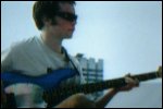 Video still: Jon sitting with his bass