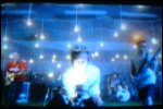 Video still: The band surrounded by light bulbs