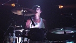 Stew highlighted behind the drums