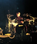 Stew surrounded by drums